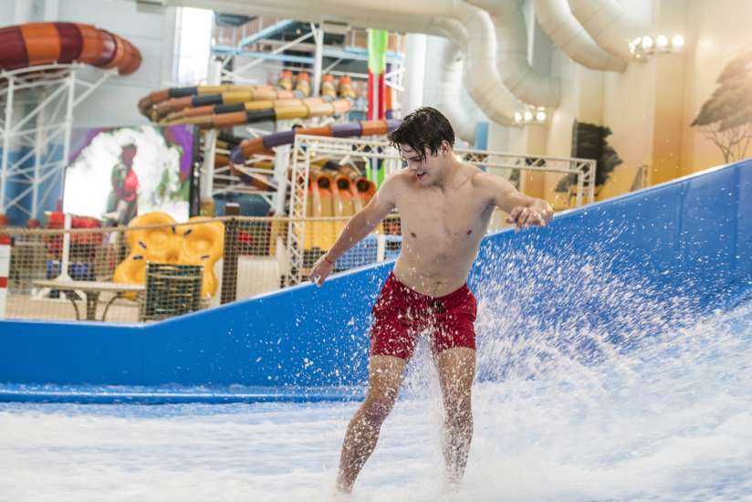 Man surfing while standing in the FlowRider