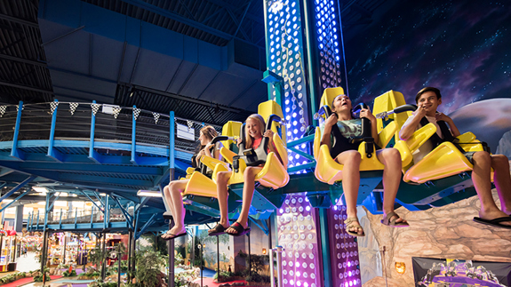a bunch of kids riding a run ride at Tom Foolerys Adventure Park