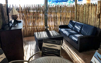 Overview of the lower cabana. Includes table, chairs, tv, and a couch.