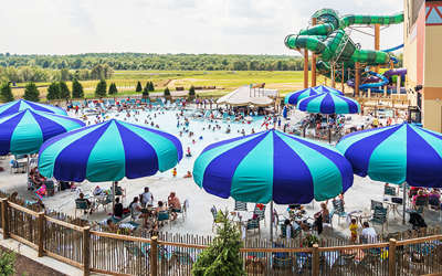 overview of the outdoor pool area with umbrellas, chairs, and pools
