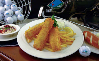 fried Fish and fries with golf equipment in the background