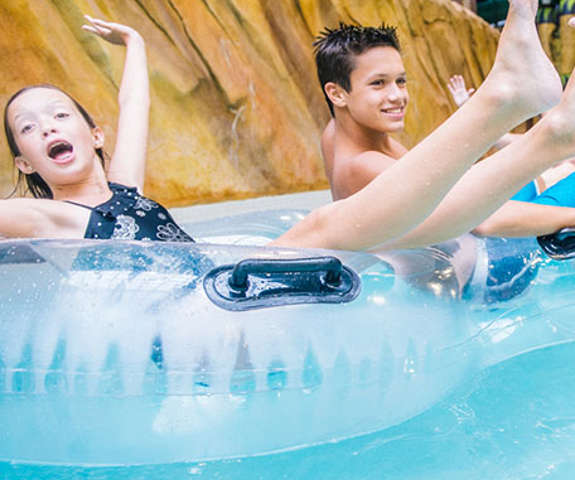 a brother and sister floating down the lazy river