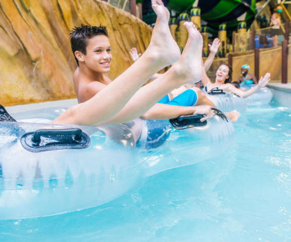 a brother and sister floating down the lazy river