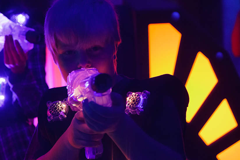 little boy playing laser tag