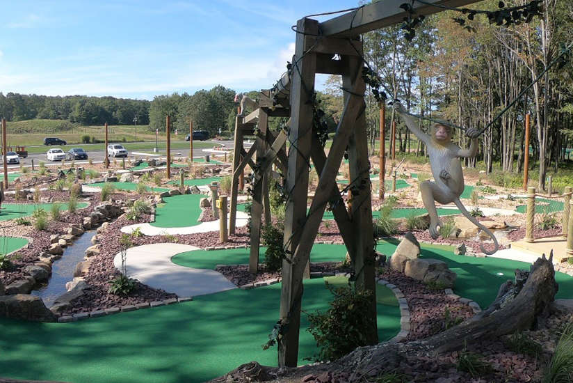 an overview of Legends of the Lost Jungle mini golf course with monkeys swinging around from post to post