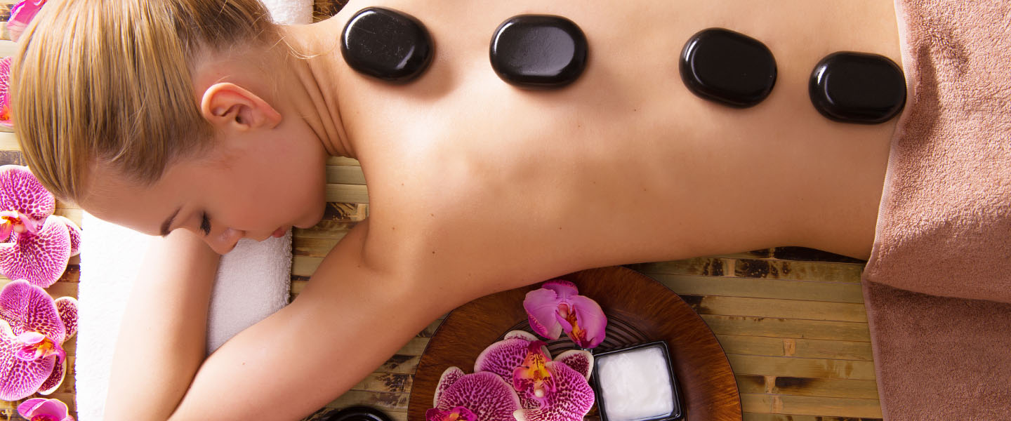 woman getting a stone massage in the spa