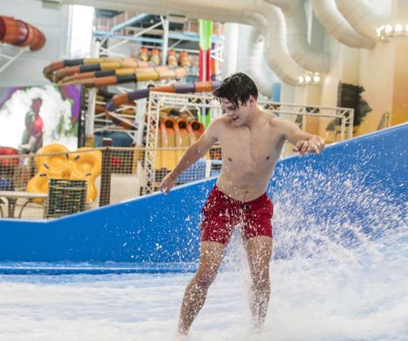 Man surfing while standing in the FlowRider