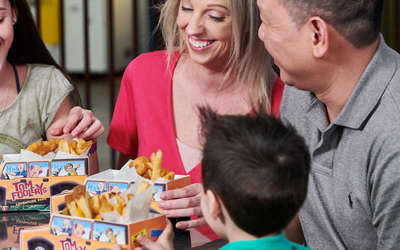 A family enjoying a meal and sharing smiles.