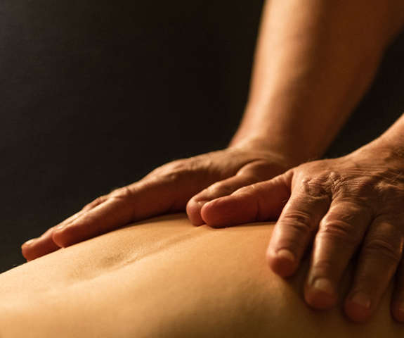 Person receiving a massage on their upper back at Spa Kalahari