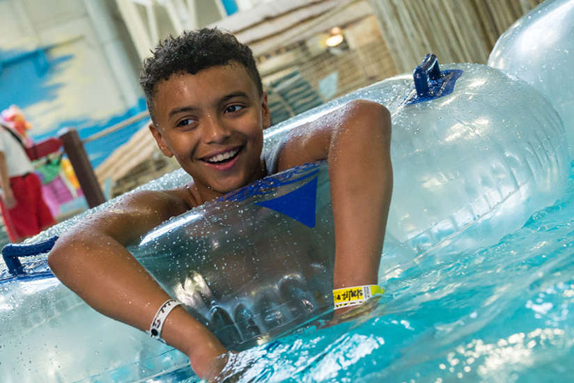 boy relaxing and smiling in the lazy river boy relaxing and smiling in the lazy river