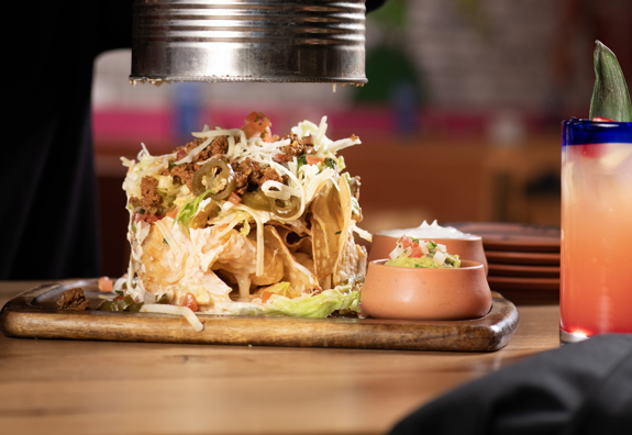 TIN CAN NACHOS- Refried Pinto Beans, Shredded Lettuce, Jalapeños, Sour Cream Cilantro, Guacamole, Queso Blanco, Pico De Gallo
