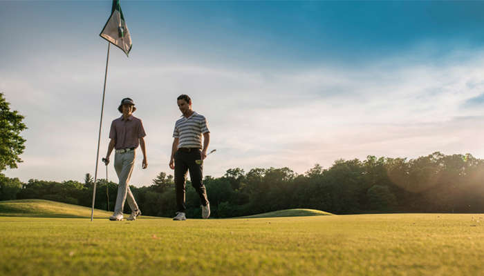 Two gentlemen walking through Trappers Turn Golf Course.