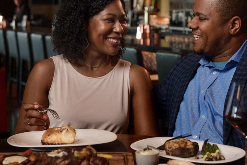 Couple enjoying a dinner and wine at Double Cut Steakhouse.