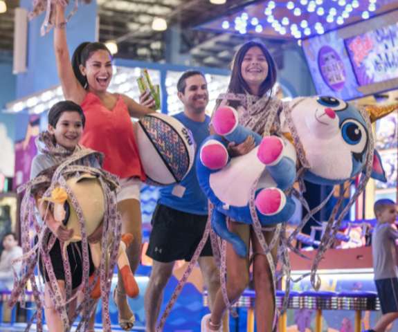 A family flaunting all the tickets they've won in the arcade.