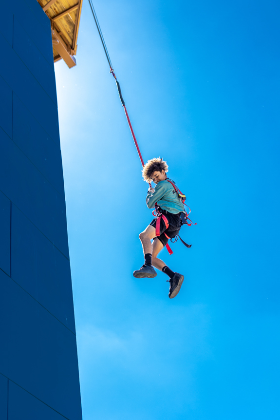 Kid gliding down the free fall tower