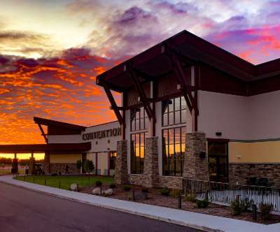 Exterior image of the Kalahari Convention Center with a illuminating sunset in the background.