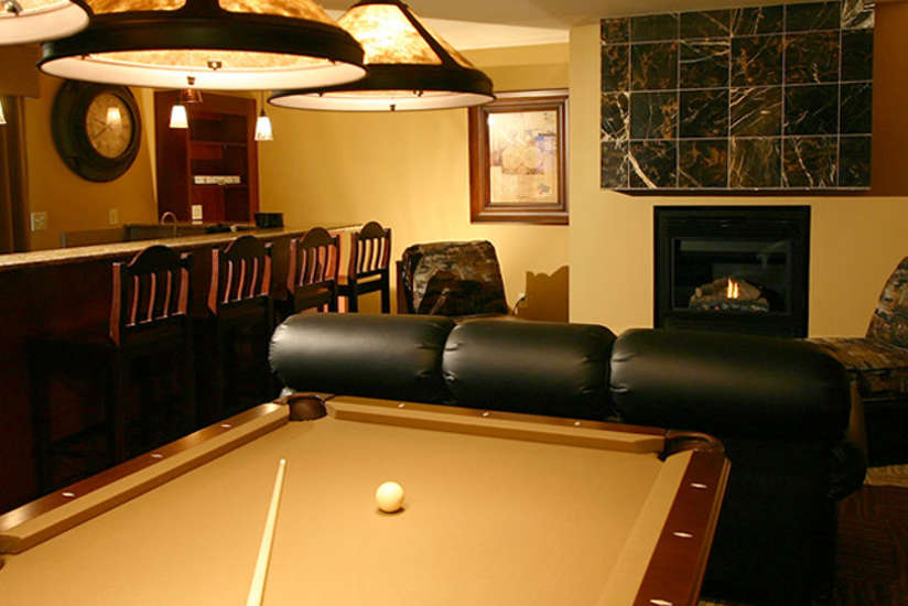 A pool table inside a Nyumba Villa living room.