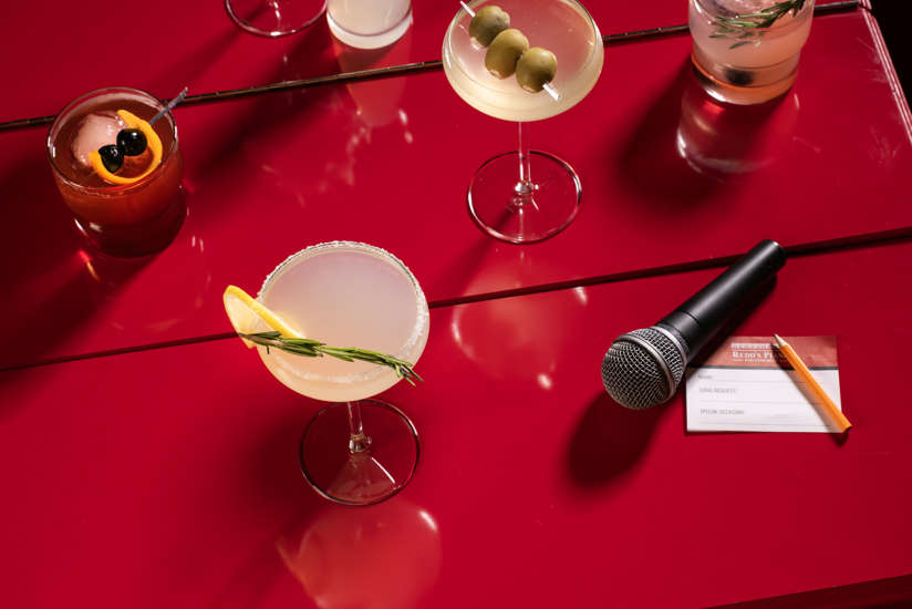 an assortment of cocktails on the piano in redd's piano bar!