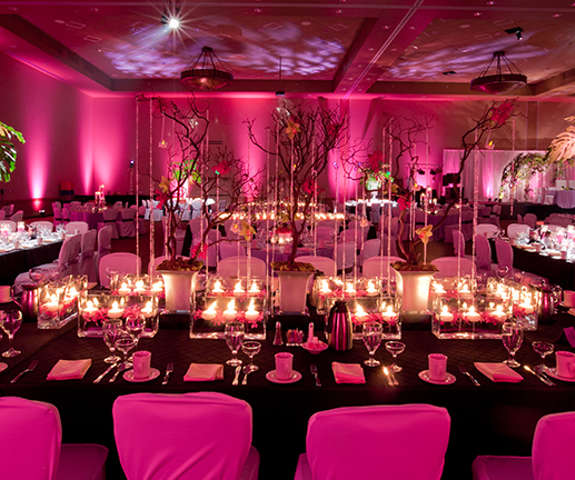 a beautiful wedding set up inside Kalahari's Convention Center with deep pink backlighting