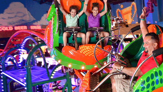Family Riding the Scream'n Centipede Roller Coaster in Tom Foolerys Adventure Park