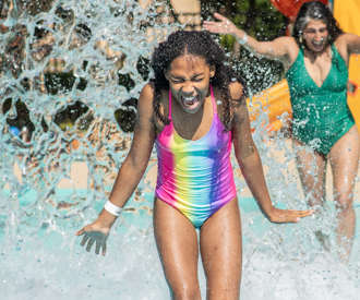 girl running through the splash pad