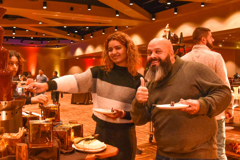 guy and girl helping themselves at the buffet