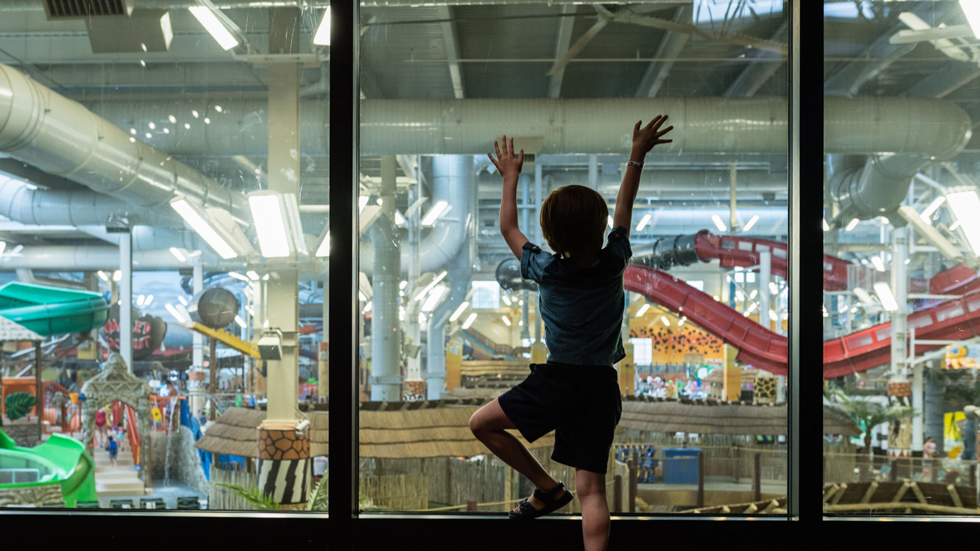 Small child admiring the indoor waterpark