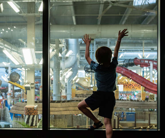 Small child admiring the indoor waterpark