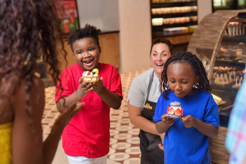 Two children excited to eat their desserts.