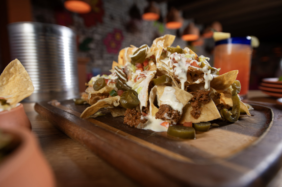 TIN CAN NACHOS- Refried Pinto Beans | Shredded Lettuce | Jalapeños | Sour Cream Cilantro | Guacamole | Queso Blanco | Pico De Gallo