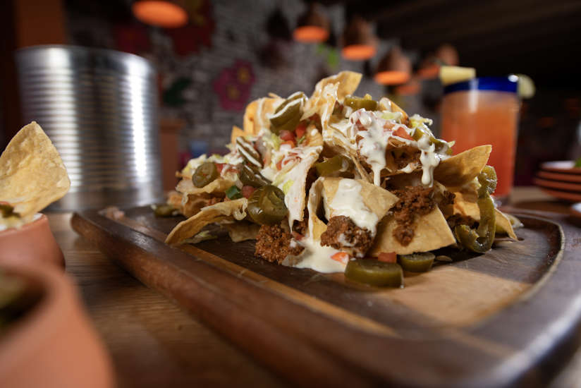 TIN CAN NACHOS- Refried Pinto Beans | Shredded Lettuce | Jalapeños | Sour Cream Cilantro | Guacamole | Queso Blanco | Pico De Gallo