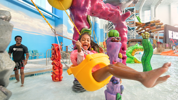 Girl Swinging in Coral Cove in the Indoor Waterpark