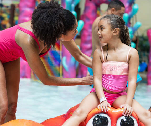 mom and girl playing in the kiddie area at the waterpark