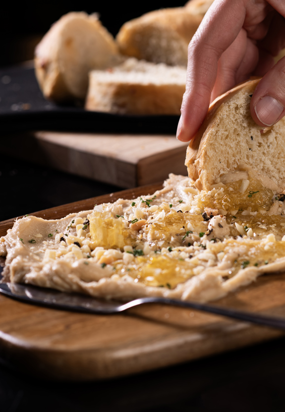 Dipping bread into butter board