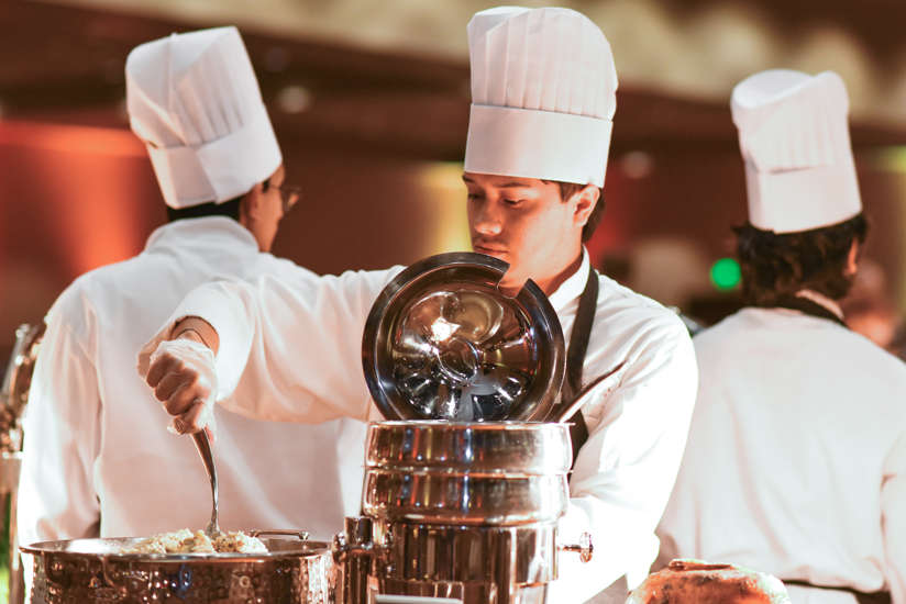 Chef serving buffet dinner