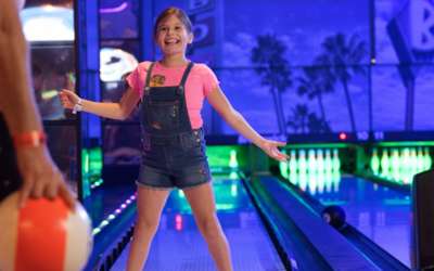 Girl excited to play bowling.