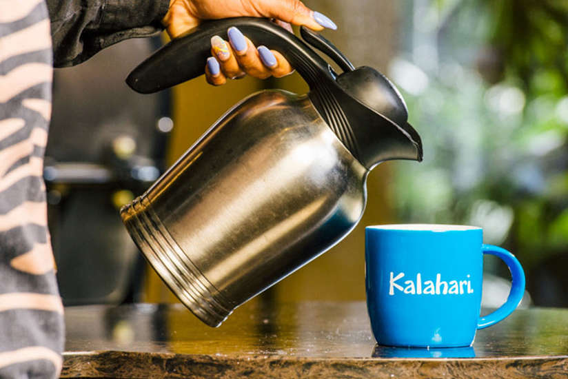 a person pouring a cup of coffee