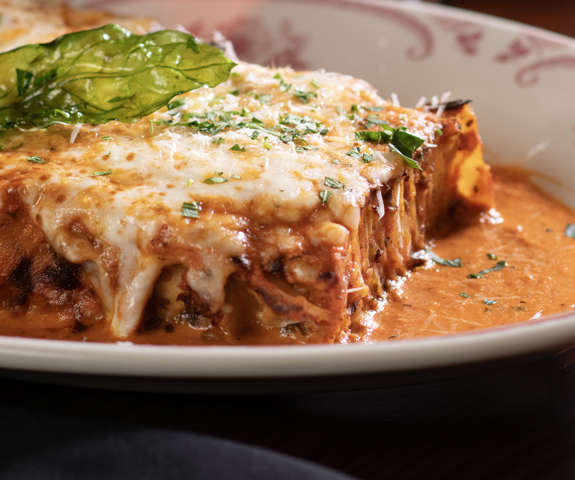 “100 LAYER” LASAGNA BOLOGNESE - Layered with housemade meat sauce, ricotta & mozzarella cheeses, grated Parmesan, finished with vodka sauce