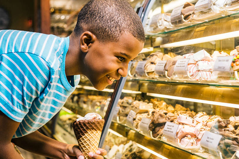 a boy with some ice cream looking at more tasty treats at the last bite