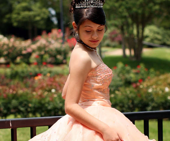 A teenage girl in a beautiful dress celebrating her Quinceanera.
