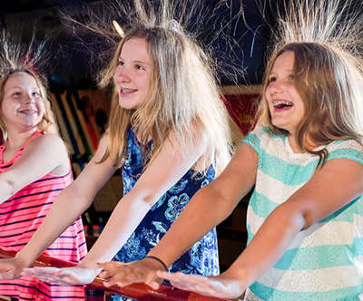 Three sisters having fun at the Tommy Bartlett Exploratory.