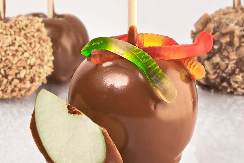 a caramel apple with gummy worms from Candy Hut