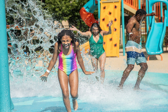 Girl splashing through the splash pad