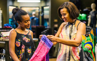 a mother and daughter taking a closer look at a garment as they shop in one of Kalahari's stores