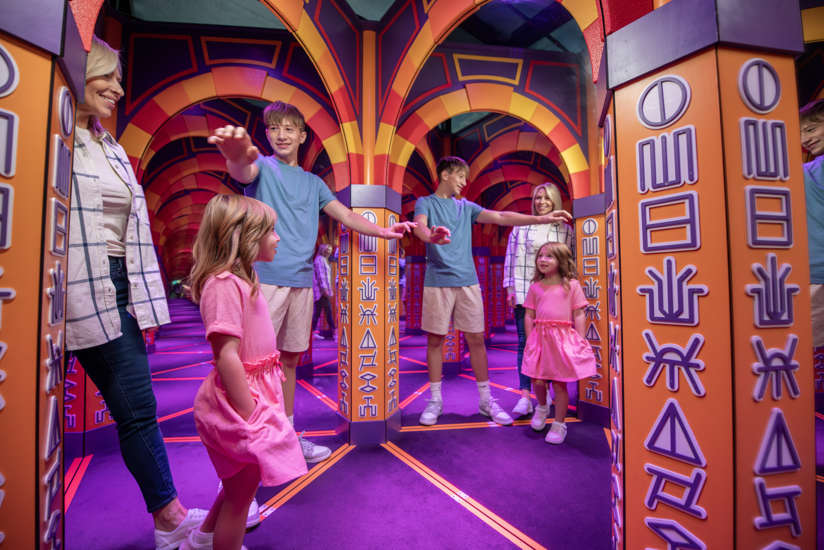 Family walking through the cave or mirrors