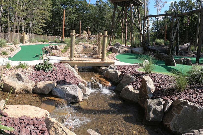 an overview of Legends of the Lost Jungle mini golf course with a water stream running through it