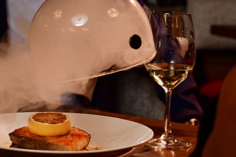 Uncovering the smoked salmon at Double Cut Steakhouse.