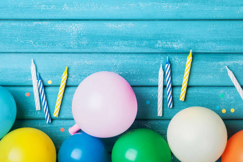 balloons and candles on a blue wood background balloons and candles on a blue wood background