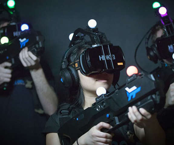 A group of kids with VR headsets on playing in our virtual reality room.