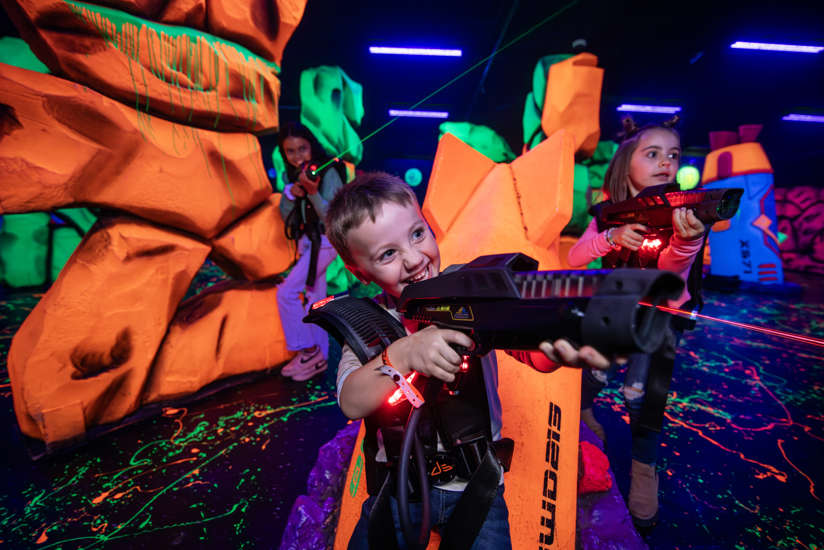 Boy and girl playing laser tag